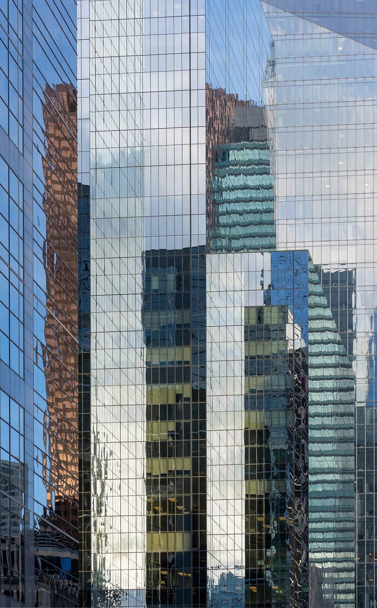 Financial district glass towers — Condivio's monetisation strategy funds each stage of the compounding business