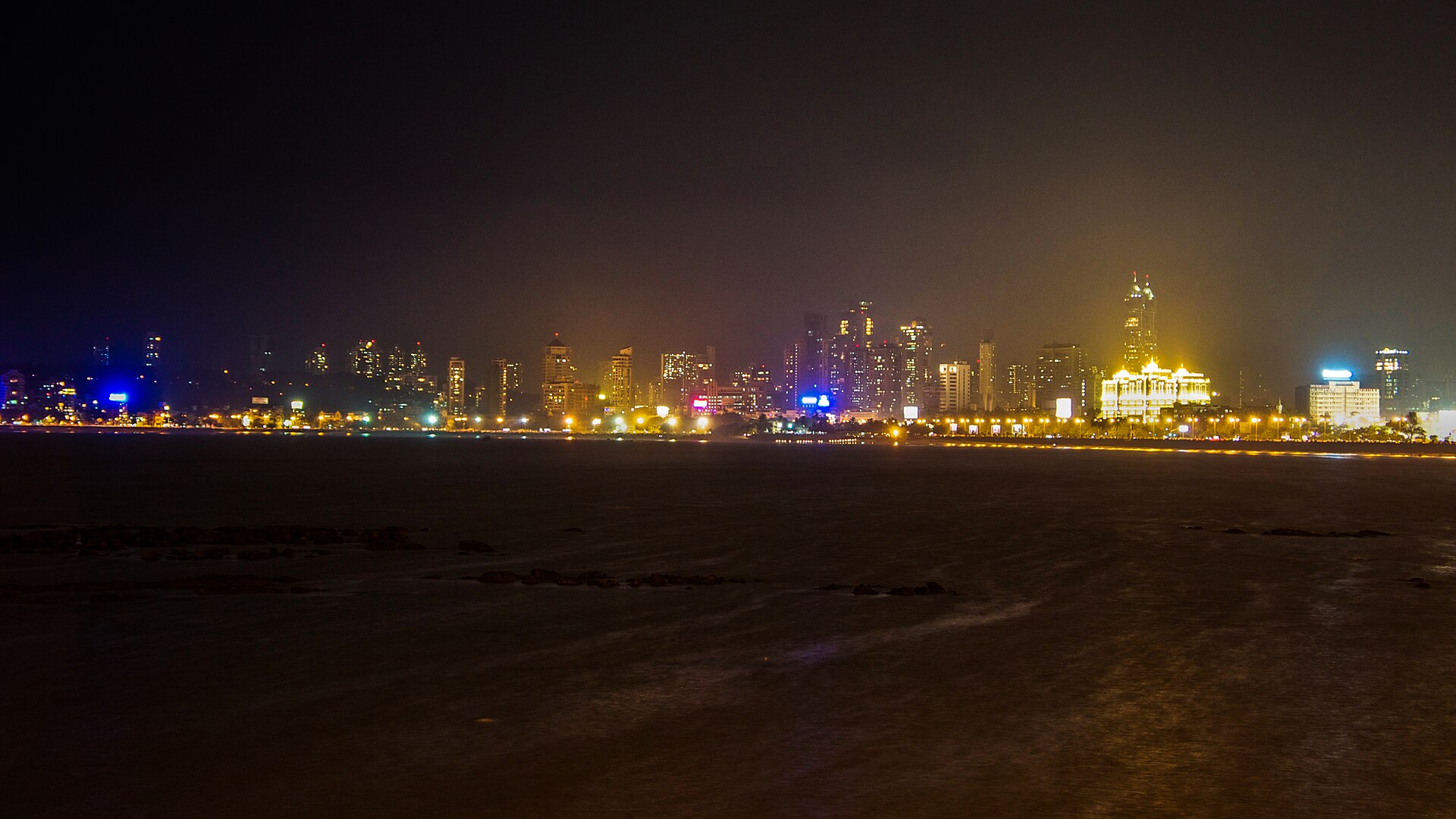 Mumbai city skyline at night, Marine Drive lights along the coast — Condivio's home market and the setting for its long-term compounding real-estate business